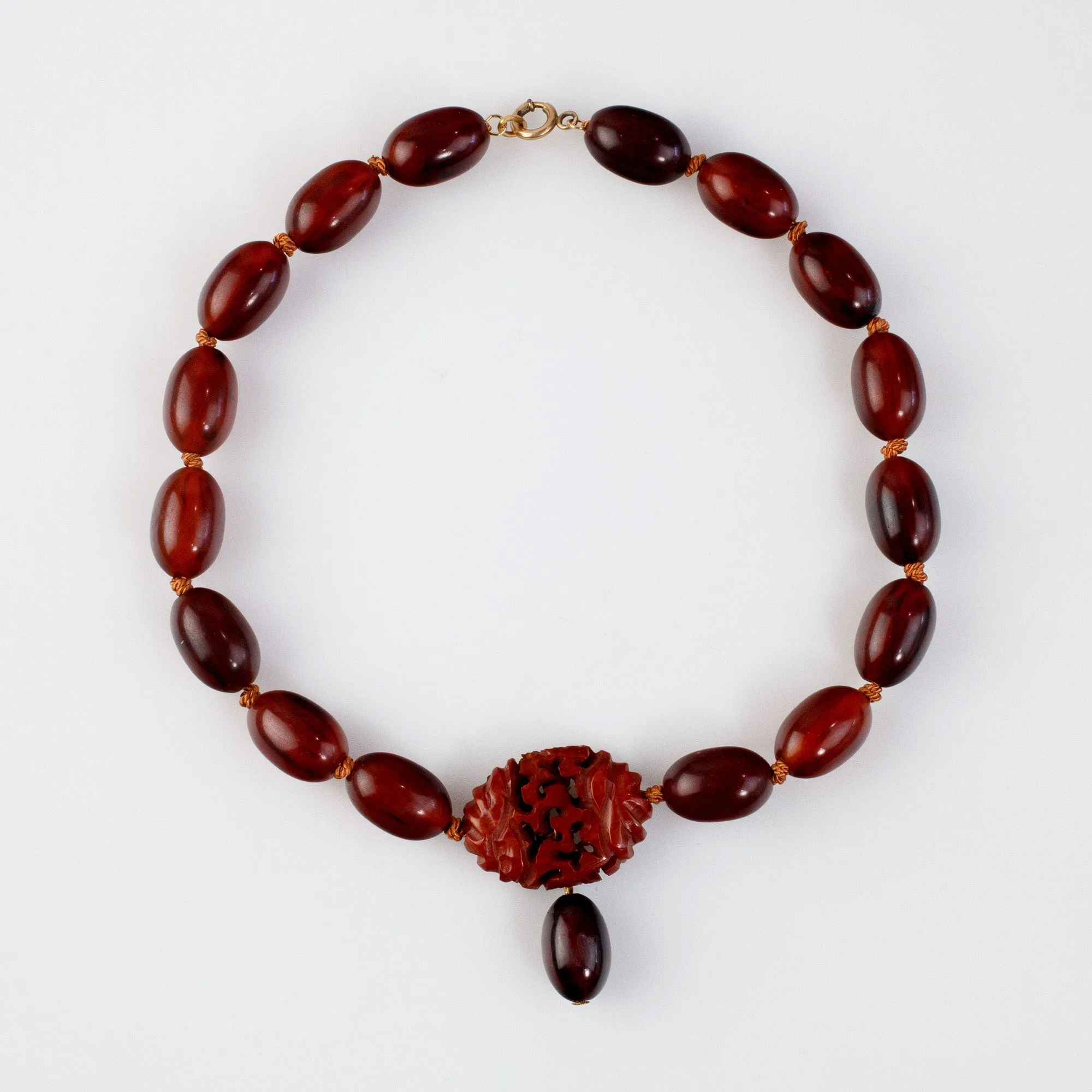 Vintage Bakelite Amber oval bead necklace with carved Bakelite focal bead.  nlbk804